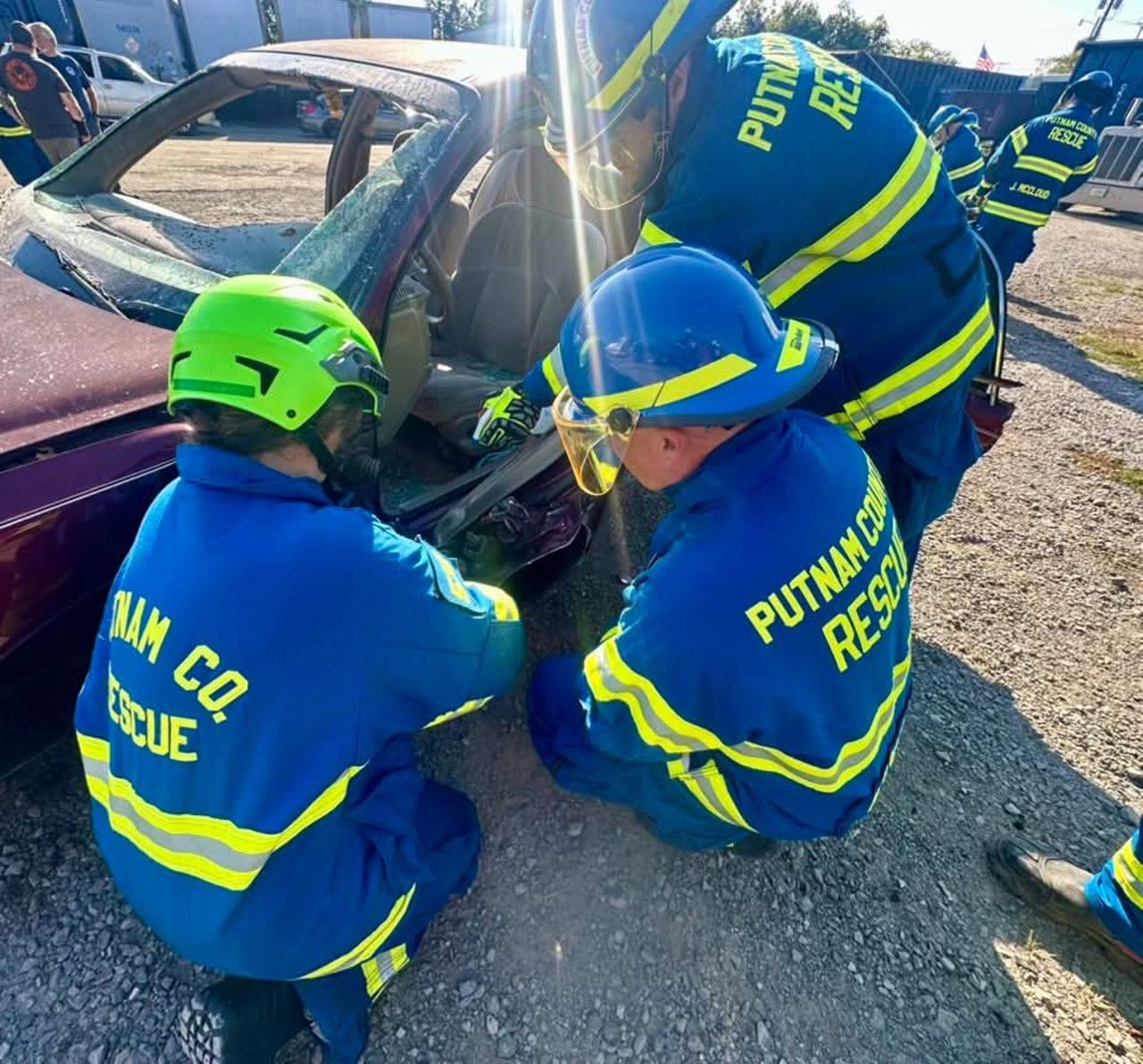 Members performing vehicle extrication on a car during training